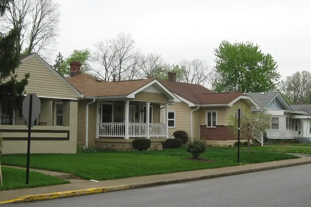 Single-story houses with front porches and lawns on a residential street in Speedway, Indiana